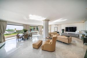 a living room with couches and a dining room at Luxury Villa with SPA in Golfe-Juan - Sea View in Vallauris