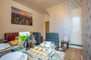 a dining room with a table with plates and wine glasses at STAYZED G - Edge Of Nottingham City Centre NG7, Great Amenities & Transport Links - Ideal for Short & Long Stays in Nottingham