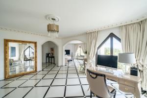 a living room with a desk and a mirror at Luxury Villa with SPA in Golfe-Juan - Sea View in Vallauris