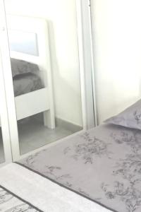 a bedroom with a mirror next to a bed at Sophie's Summer House in Nea Fokea