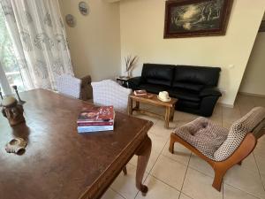 a living room with a table and a couch at Lydia’s house in Argostoli