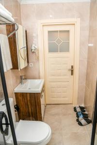a bathroom with a toilet and a sink and a door at Asitane Life Hotel in Istanbul