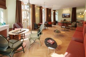 a living room with chairs and tables and a couch at Hotel De Cambis Best Western Premier Collection in Avignon
