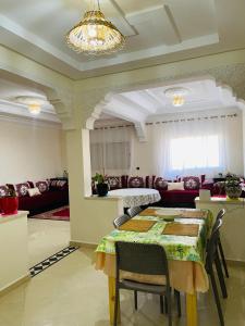 uma sala de jantar com uma mesa e uma sala de estar em Dar Malaika em Oualidia