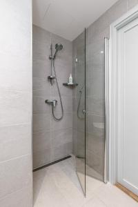 a shower with a glass door in a bathroom at Vallikraavi Cozy Apartment in Tartu