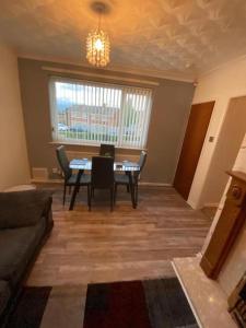 a living room with a table and chairs and a window at Spacious Luxurious Serviced Accommodation 3 in Warmsworth