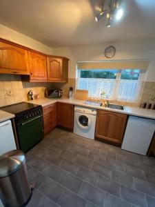 a kitchen with a sink and a dishwasher at Spacious Luxurious Serviced Accommodation 3 in Warmsworth