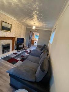 a living room with a couch and a fireplace at Spacious Luxurious Serviced Accommodation 3 in Warmsworth