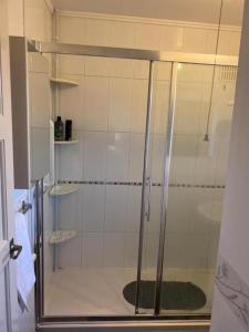 a shower with a glass door in a bathroom at Spacious Luxurious Serviced Accommodation 3 in Warmsworth