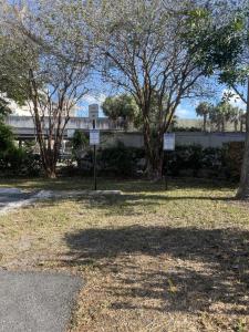 a park with trees and signs in the grass at The Blue Wave Suite Unit C in St Petersburg