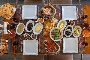 a table topped with plates and bowls of food at Dantela Butik Hotel in Çeşme