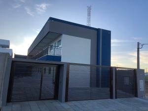 a building with a large garage door in front of it at Vêneto Flat Residence (AP-13) in Primavera do Leste +5 photos