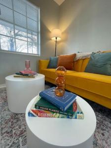 a living room with a couch and a table with books at Colorful home St Petersburg in St Petersburg