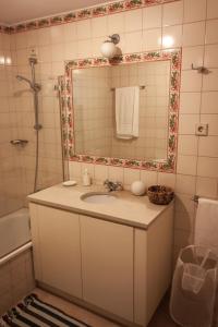 uma casa de banho com um lavatório e um espelho em Palácio da Quinta da Portela II em Coimbra