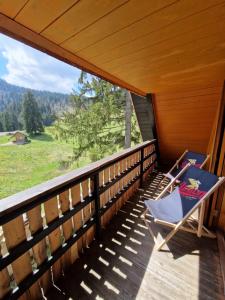 a chair on the porch of a cabin at OTO`S CABIN in Radovljica