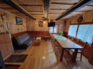 a living room with a table and a couch at OTO`S CABIN in Radovljica