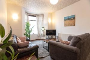 a living room with two couches and a tv at April Disc - Long Stay - Contractors in Bristol