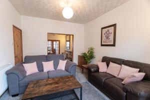 a living room with two couches and a table at April Disc - Long Stay - Contractors in Bristol