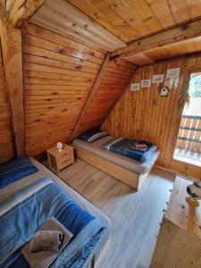 a room with two beds in a log cabin at OTO`S CABIN in Radovljica
