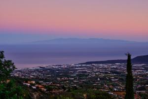 a view of a city at sunset at Tizziri rural in Santa Cruz de Tenerife