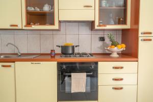 a kitchen with a stove with a pot on it at AffittaSardegna - Casa Merisi in Alghero