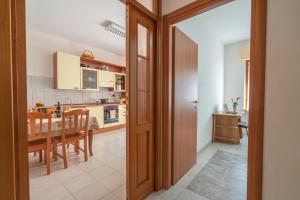 a kitchen and dining room with a table and chairs at AffittaSardegna - Casa Merisi in Alghero +17 photos