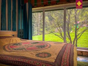 1 dormitorio con cama y ventana grande en Kitica house, en Verkhovyna