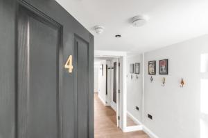 a hallway with a door with the number four on it at Nadler Studios in Norwich