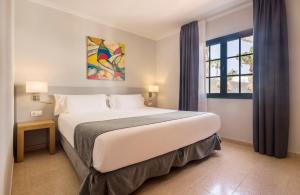 a bedroom with a large bed and a window at ILUNION Costa Sal Lanzarote in Puerto del Carmen