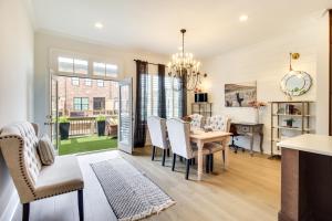 a dining room and living room with a table and chairs at Charming Savannah Townhome - 1 Block to Riverwalk! in Savannah