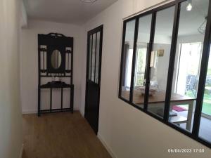 a living room with a mirror and a room with a table at La maison d'en haut in La Capelle-et-Masmolène