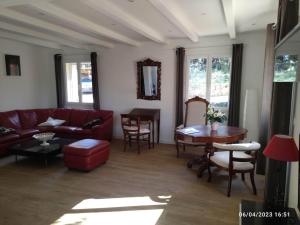 a living room with a red couch and a table at La maison d'en haut in La Capelle-et-Masmolène +42 photos