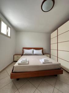 a bedroom with a bed with two towels on it at Villa Santo Stefano in Monopoli