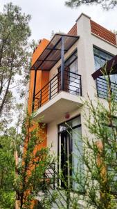 a building with a balcony on top of it at Shekvetili Holiday House - Day Off in Shekvetili