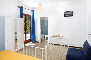 a living room with a toilet and a table at B&B Sorrento Sunshine in Sorrento