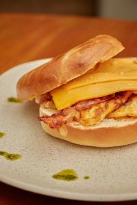 a breakfast sandwich with eggs and cheese on a plate at Epic Boutique Hotel in Medellín