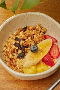 a bowl of granola and fruit on a table at Epic Boutique Hotel in Medellín