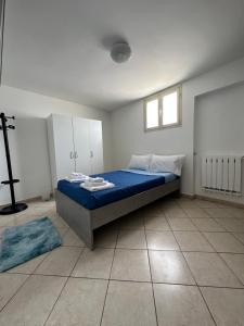 a bedroom with a bed with blue sheets and a window at Villa Santo Stefano in Monopoli