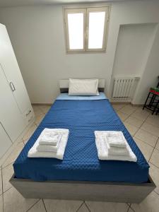 a large blue bed in a room with a window at Villa Santo Stefano in Monopoli