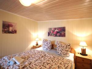 a bedroom with a bed and two paintings on the wall at Rogk, Christa in Zingst