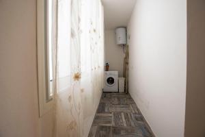 a hallway with a door and a window and a microwave at Diamante Apartments in Valledoria