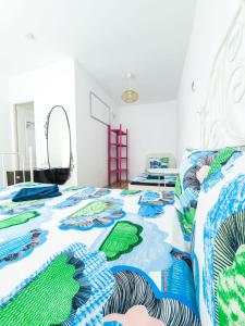 a bedroom with two beds with blue and green quilts at OZ Vama Veche in Vama Veche