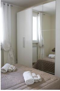 1 dormitorio con espejo y toallas en la cama en Villetta Nardò, en Nardò