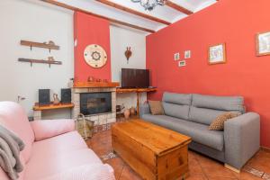a living room with two couches and a fireplace at Barranco de las Maravillas in Teruel