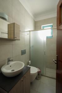 a bathroom with a sink and a toilet at Meltemi House in Mastihari