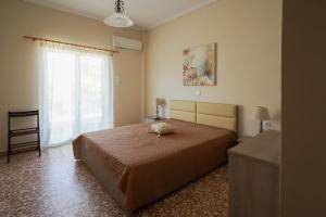 a bedroom with a bed and a window at Meltemi House in Mastichari