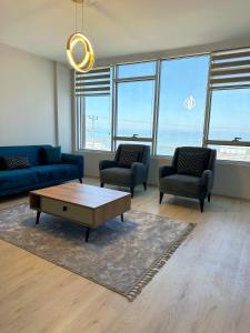 a living room with couches and a coffee table at İMA APART in Trabzon