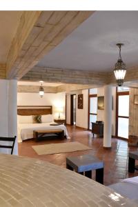 a bedroom with a bed and a room with a table at Casa María Elena in San Miguel de Allende