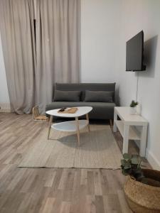 a living room with a couch and a table at VFT Puerta de Córdoba in Baeza