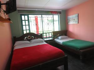 Postel nebo postele na pokoji v ubytování Finca Hotel Guayacundo
